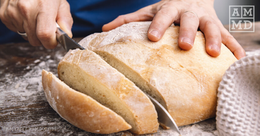 Slicing a loaf of fresh bread - The Benefits of Going Gluten-free with Autoimmune Disease - Amy Myers MD®