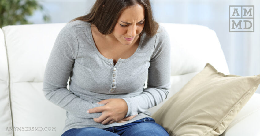 Woman Clutching Stomach - The Leaky Gut and Autoimmune Disease Connection - Amy Myers, MD®