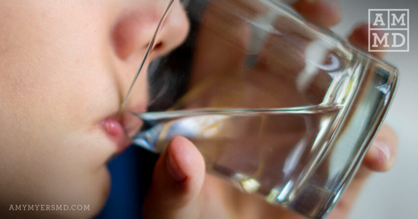 Child sipping water from a glass - The Toxin, Heavy Metal & Thyroid Connection - Amy Myers MD®