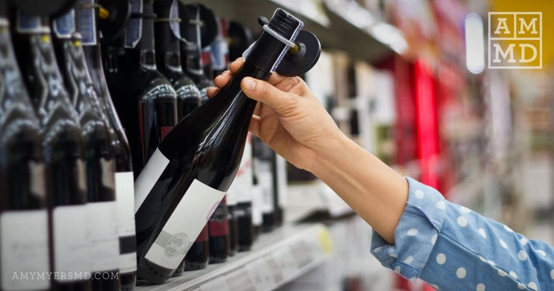 Person grabbing wine bottle off of store shelf - Being Sober Curious is More Than Just a Trend - Amy Myers MD®