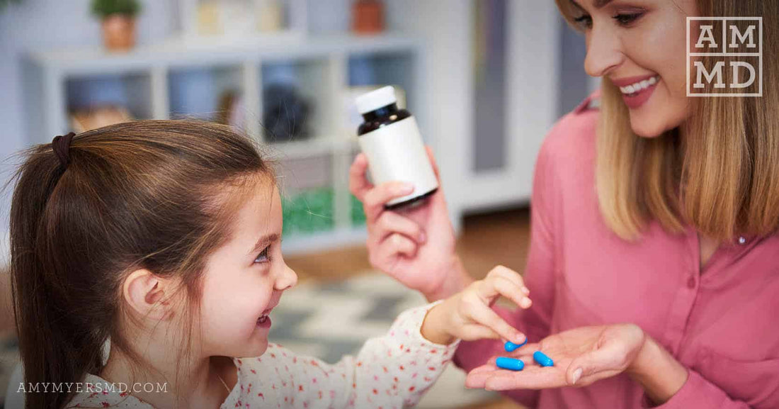 Little Kid Looking at MultiVitamin in Mom's Hand - Should Kids Take Vitamins at All? - Amy Myers MD®