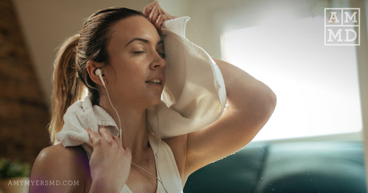 Woman wiping sweat off her face - The benefits of sweating - Amy Myers MD®