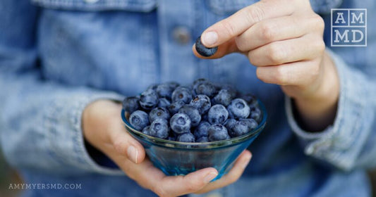 Woman holding blueberries - Cortisol Detox Diet - Amy Myers MD®