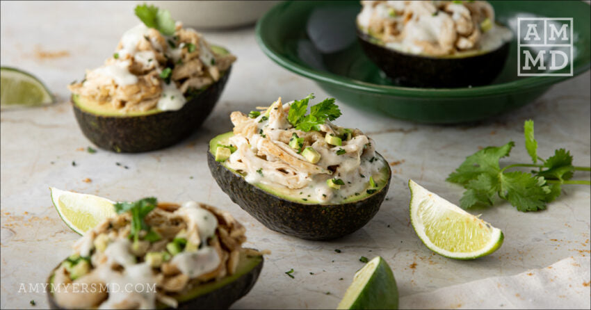 Avocados with stuffing on a table - Stuffed Avocados with Cilantro Cream Sauce- Amy Myers MD®