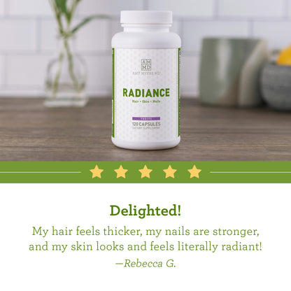 A bottle of Radiance - Hair, Skin and Nails Supplement on a tabletop with a 5 star review, "My hair feels thicker, my nails are stronger, and my skin looks and feels literally radiant!"- Rebecca G.  Amy Myers MD®