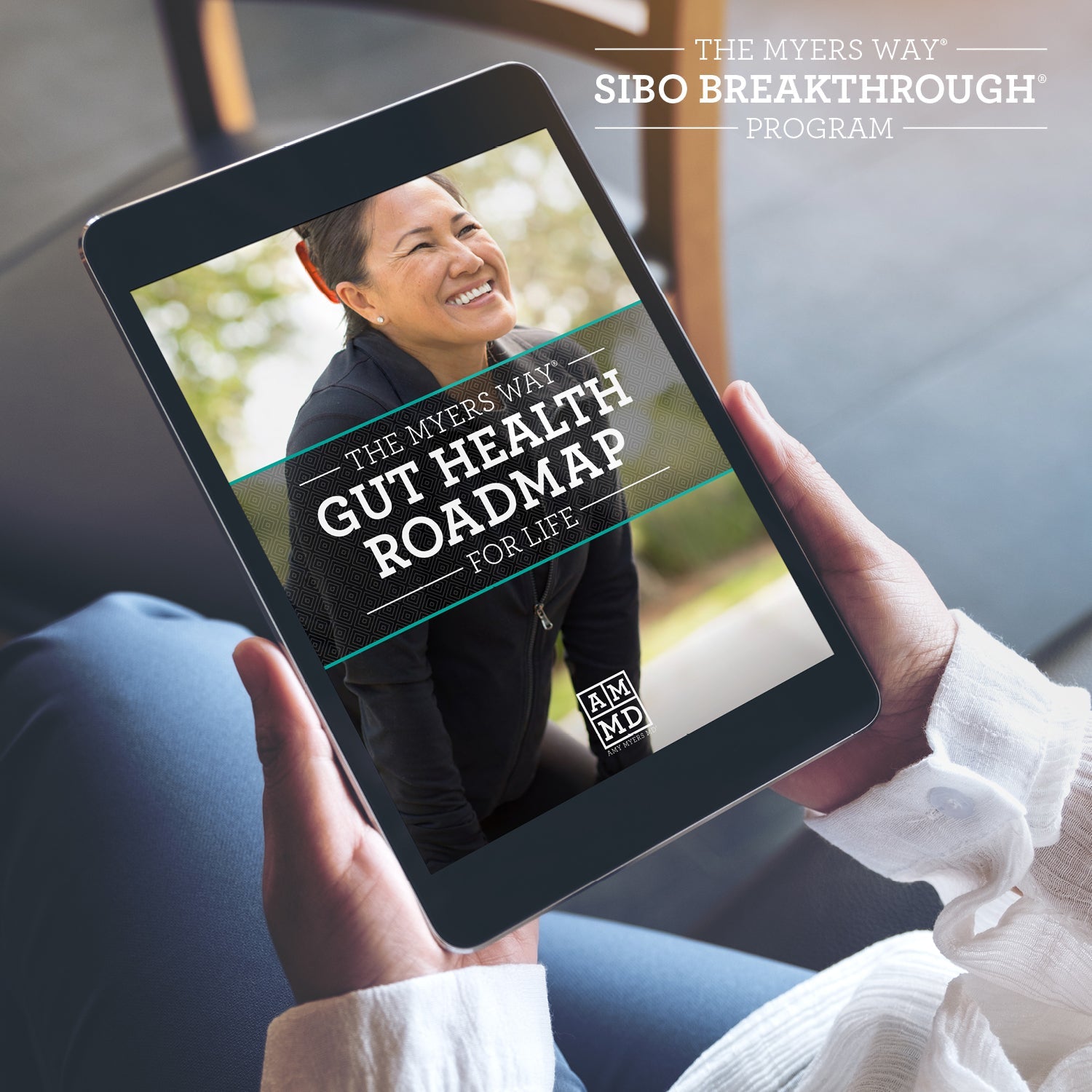 A Woman views The Upgraded SIBO Breakthrough Program Gut Health Roadmap on a tablet - Amy Myers MD®