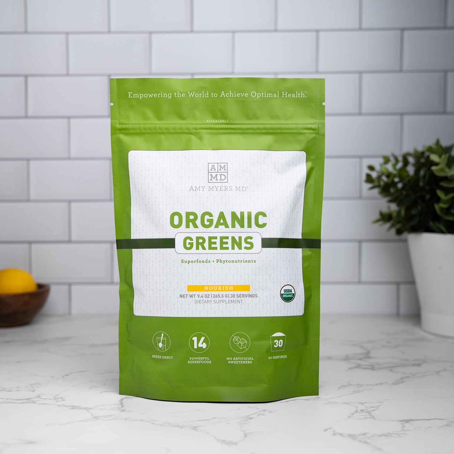 A bag of Organic Greens sitting on a granite countertop.